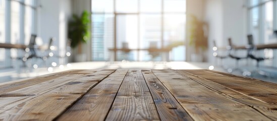 A wooden board was placed on the table in an empty office room with a blurred backdrop ideal for a copy space image