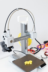A 3D printer creates objects with colorful bands and innovative designs using additive technology