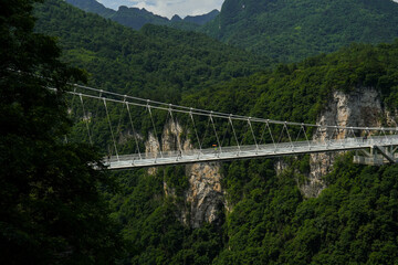 Glass bridge of Zhangjiajie China Tianzishan with blue sky, Zhangjiajie national forest park, China, concept of world heritage, avatar, heritage peak or cliff mountain, tourist attraction famous place