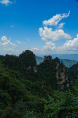 Naklejka premium Zhangjiajie national forest park, China, Glass bridge of Zhangjiajie China Tianzishan with blue sky, concept of world heritage, avatar, heritage peak or cliff mountain, tourist attraction famous place