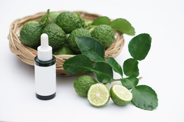 Kaffir lime, bergamot fruits on basket and bottle of serum. Concept, Health care from nature with medicinal herbal property to be extracted for beauty products or cosmetic.                          