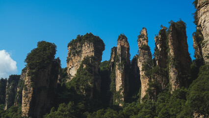 Fototapeta premium Zhangjiajie national forest park, China, Glass bridge of Zhangjiajie China Tianzishan with blue sky, concept of world heritage, avatar, heritage peak or cliff mountain, tourist attraction famous place