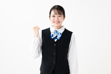 ガッツポーズをする制服姿の女性