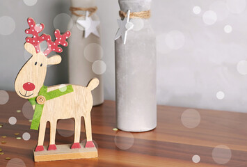 Decorative Christmas composition reindeer and Christmas tree, vases with stars. Festive decoration for living room. 
