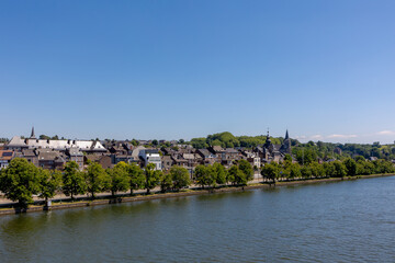 Fototapeta premium Summer cityscape with view of Vise city in Belgium under blue sky, Architecture traditional house and church along the Meuse river, Visé is a city and municipality of Wallonia in the province of Liège