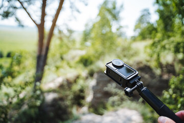 Make your outdoor experiences unforgettable by using an action camera on a selfie stick to capture the breathtaking beauty of nature during your adventures and explorations