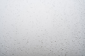 Background with raindrops on light glass.