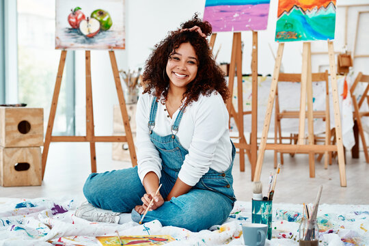 Woman, portrait and home studio with creativity, painter and canvas project with paint and art brush. Smile, happy and confidence of an artist ready for workshop with painting and artistic talent