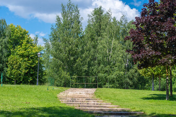 Empty stone staircase in a public park blocked by a fence. The passage is blocked by the administration.