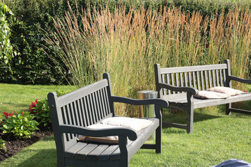 Grey painted wooden bench in park. Nature and recreation. Country estate in summer. 