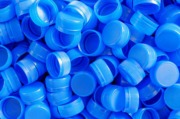 Top view blue plastic bottle caps.Recycling collection and production processing plastic bottle...