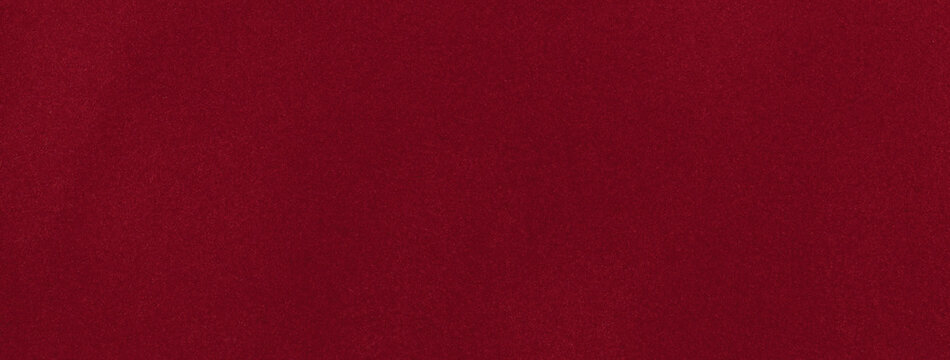 Dark red matte background of suede fabric, closeup. Velvet texture of wine seamless textile, macro.
