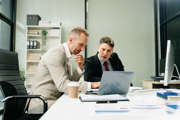 Happy businesspeople while collaborating on a new project in an office