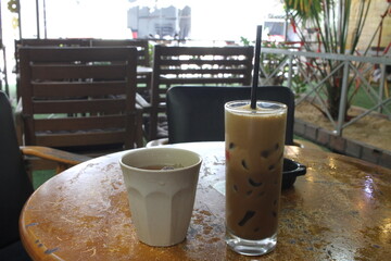 A Glass of Black Coffee and a cup of Tea at a Cafe in Vietnam