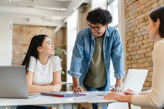 Cooperative young colleagues business partners friends college students classmates having discussion negotiation about working studding project start up issues in the coworking space office