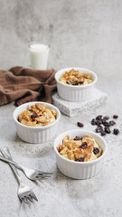 Traditional bread pudding with raisins and almond in ramekin cup vertical
