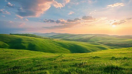 A landscape view of rolling hills covered with green grass, under a dramatic cloudy sky during sunset.