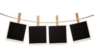 Four blank polaroid photos hanging on a clothesline with wooden clothespins against a white background. Perfect for memory-themed designs, photo album layouts, or adding a touch of nostalgia to any pr