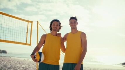 Medium shot of two male beach volleyball athletes high-fiving after winning a fun game on a sunny day.