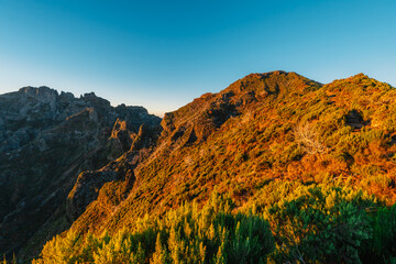 Hiking on the highest peak of Madeira Pico Ruivo next to the cottage Abrigo do Pico Ruivo. Views of...