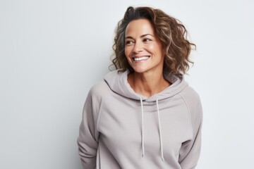 Obraz premium Portrait of a happy woman in her 40s dressed in a comfy fleece pullover isolated in white background