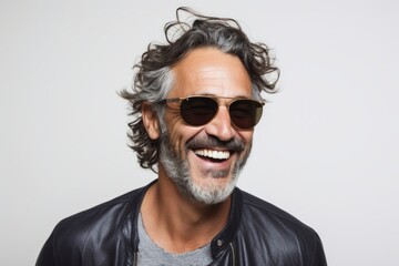 Obraz premium Portrait of a grinning man in his 40s wearing a trendy sunglasses over white background