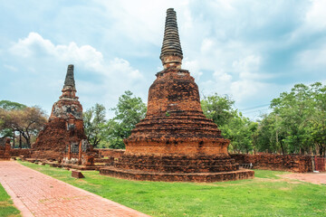 Fototapeta premium Wat Phra Si Sanphet ancient temple with small red brick stupas in Ayutthaya historical park, Thailand, Asia. Historical Buddhist architecture on archaelogical site in ancient capital city of Siam