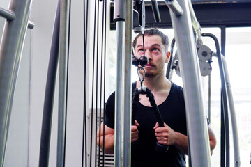 Young man exercising in the fitness center Exercise for health.