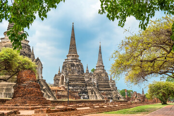 Fototapeta premium Wat Phra Si Sanphet ancient temple with three big Stupas in Ayutthaya historical park, Thailand, Asia. Historical Buddhist architecture of Royal palace in ancient capital city of Siam