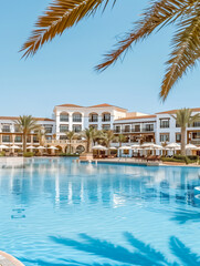 Luxury hotel poolside with palm trees and sun loungers