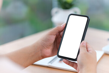 Mockup image of woman hands holding smartphone with blank screen for advertise text.