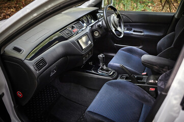 Fototapeta premium Car steering wheel and car sensors, inerior background, modern city car elements close view. Car inside interior