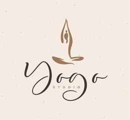 Woman sitting in lotus position with lettering drawing on beige background