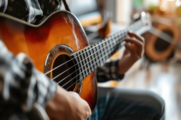 Fototapeta premium Young man playing on the guitar by the computer, online course, teacher or student
