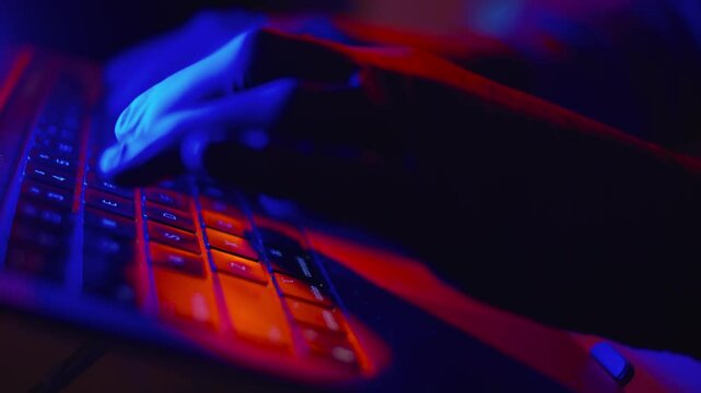 Hacker with Black Gloves Typing on Computer Keyboard in Slow Motion