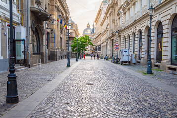 Street view of Old town in Bucharest, with old buildings and a paved road. 