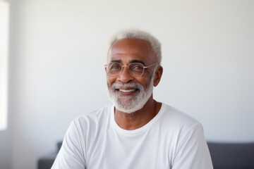 Obraz premium Portrait of a content afro-american man in his 80s sporting a breathable mesh jersey while standing against modern minimalist interior