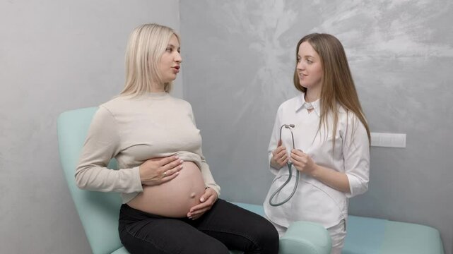 Female doctor using stethoscope examining pregnant woman in clinic. Medical exam pregnant woman