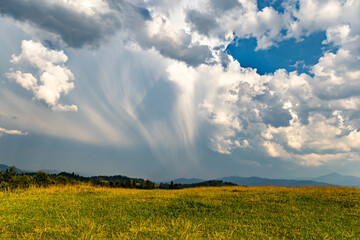 Obraz premium Beautiful landscape in the mountains with clouds on a summer day.