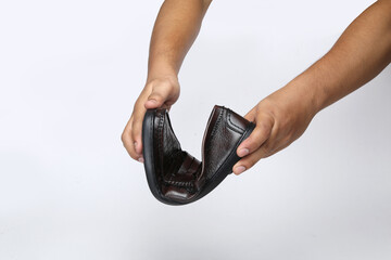 leather loafers slip on shoes holding in hand on light background