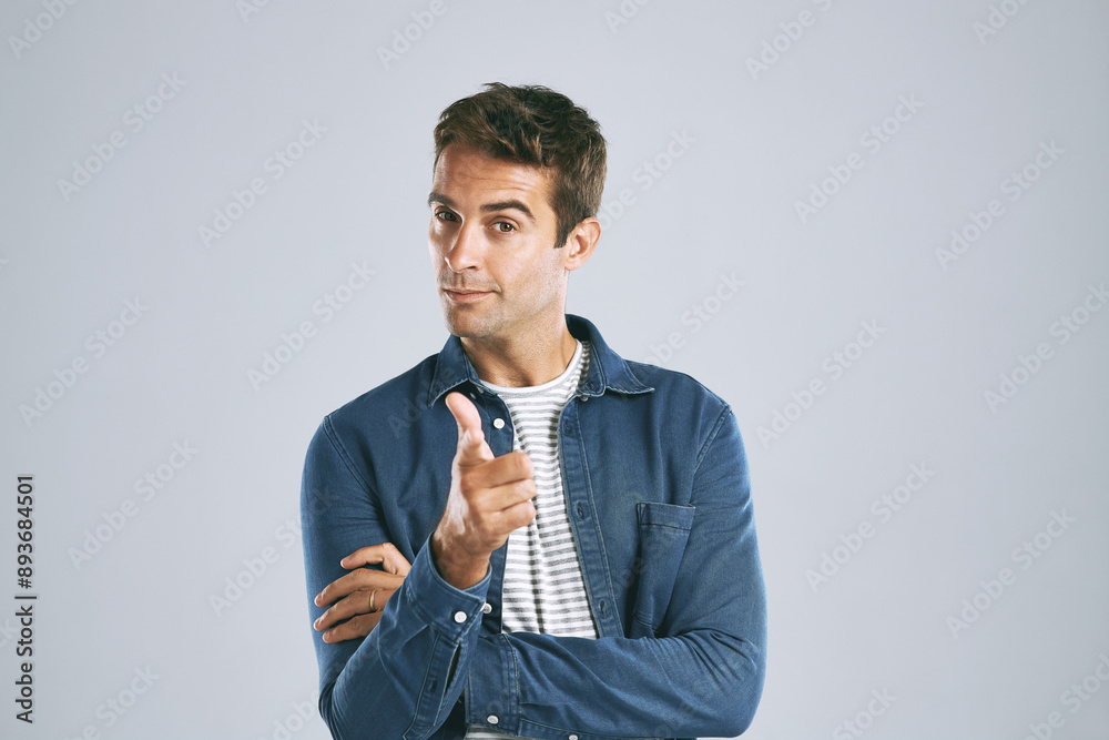 Poster thinking, pointing and man in studio, portrait and happy with smile in mockup, choice and gesture. s