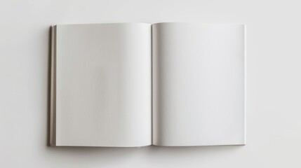 Open Blank Book on White Surface Top view of an open blank book with white pages on a white surface, perfect for background or design template