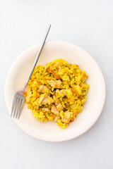 Stewed rice with chicken breast and mixed salad with radishes and various seeds, a delicious hearty lunch or dinner