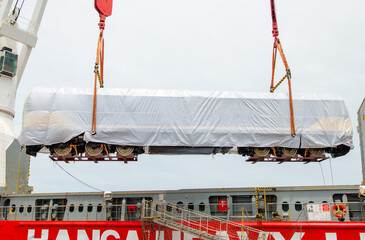 Unloading operation of project  cargo with port heavy lift cranes A crane on a large cargo ship...