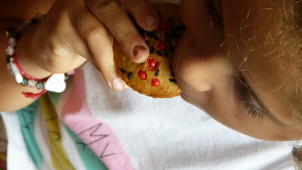 Girl eating a muffin.