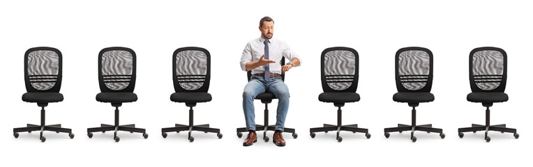 Man sitting in an office chair and checking time on watch