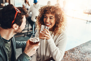 Date, couple and restaurant with drink, discussion and happy from romance and talk together. Pub, smile and people with conversation, love and bonding with beer and alcohol at bar for anniversary