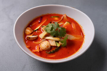 Tasty asian soup with shrimps and vegetables served on plate. 