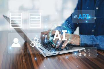 A businessman uses a computer to integrate Application Programming Interfaces (APIs), Artificial...