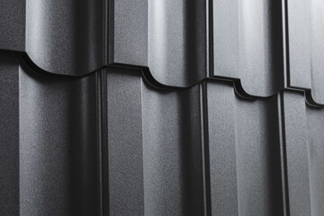 Close-up view lightweight galvanised steel roofing sheet. Modular tile effect roof panel. Traditional metal shingle tiles. Popular profiled metallic pantile mimic clay or concrete slate